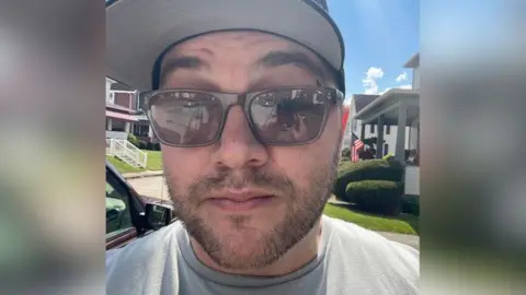 Timothy Kuin Kuin Kuin's family wears sun glasses and a black hat on a selfie photo