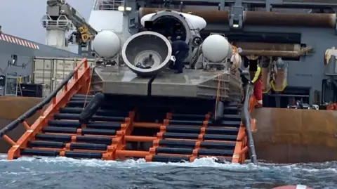 US Coast Guard The Titan submersible is seen after being lifted out of the sea - with its dome component loose