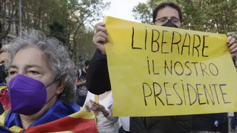 EPA A demonstrator holds a banner reading in Italian language "Free Our President" as several dozens people rally in front of Italian Consulate