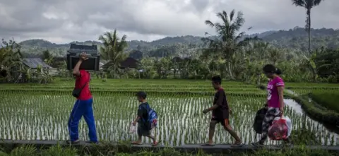 Getty Images People move their property as they leave their home near Mt Agung