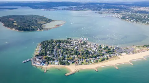 Aerial panorama view of Sandbanks Beach and Cubs Beach in Bournemouth, Poole and Dorset, England. Wide angle daytime.