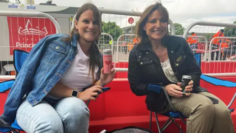 Daughter and mum Sinead 34, and Justine, 52 sat in camp chairs waiting in the queue for the Pink concert 