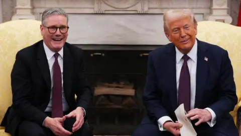 PA Media UK Prime Minister Sir Keir Starmer and US President Donald Trump sit side by side in the Oval Office