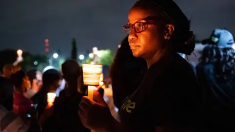 Envoy Studios Chioma Agwuegbo holding a candle lantern in Aubja, Nigeria