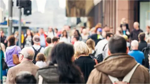 Getty Images Crowd walking down street in Edinburgh