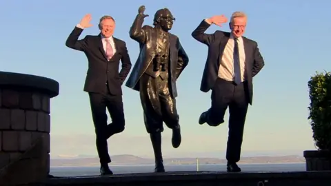 BBC David Morris and Michael Gove with a statue of Eric Morecambe