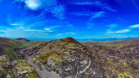 PATRICK O'NEILL An aerial photo of the vast Rhinogydd mountain area. It shows a large mountain scorched by fire.
