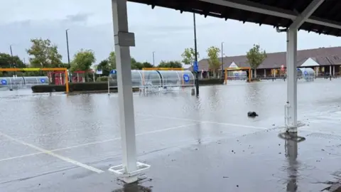 Tesco carpark in Abingdon. There is standing water covering most of the carpark.