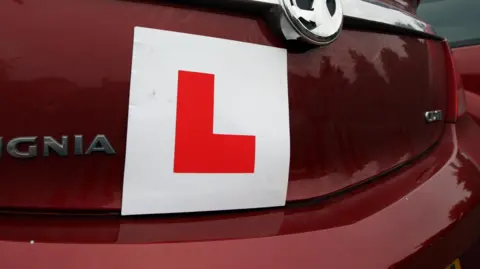 BBC A learner plate on the back of a car
