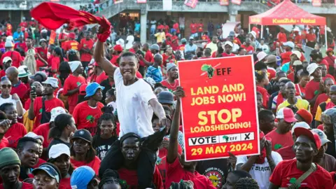 Getty Images A crowd welcomes Economic Freedom Fighters (EFF) party President Julius Malema as he speaks during an event on May 16, 2024