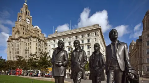 The Beatles statue at Pier Head in front of the Liver Building