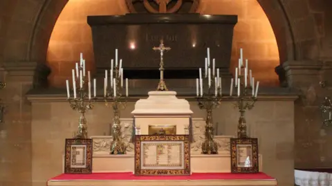 Hampshire and Isle of Wight Constabulary Altar with three plaques lined up along its front and large candelabra lined up behind.