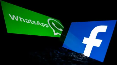 Getty Images The WhatsApp and Facebook logos are seen against a dark background, framed by phone screen bezels
