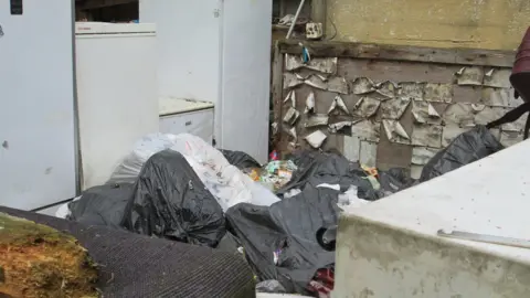 Natural Resources Wales Bags of rubbish and old white goods