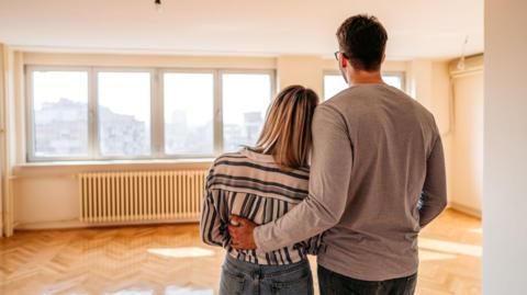Couple looking at empty room