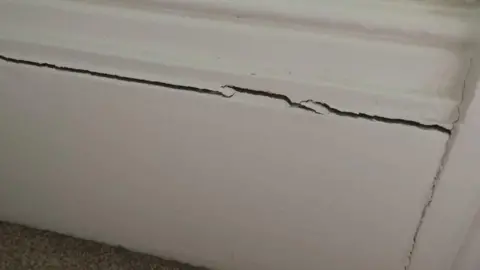 A tall skirting board is severely cracked in one of the Wilson's bedrooms.