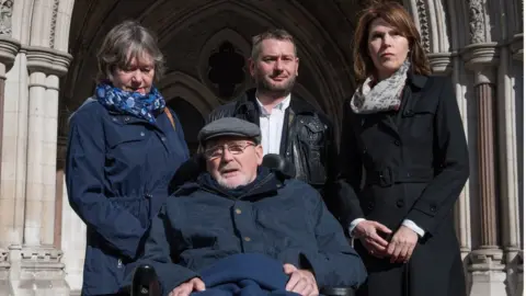 PA Media Noel Conway outside The Royal Courts of Justice with his family in 2017