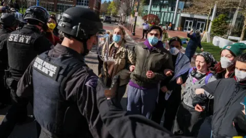 Getty Images Police square off with protesters at Northeastern University in Boston