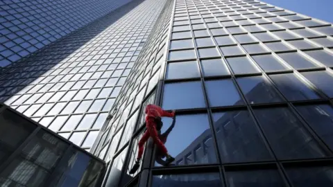 Alain Robert climbs the Total Tower in Paris on 17 September