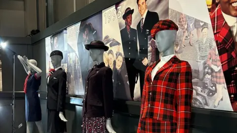 Aerospace Bristol A group of mannequins are lined up at Aerospace Bristol in different uniforms worn by air crew down the years. Closest to the camera is a bold black and red tartan uniform