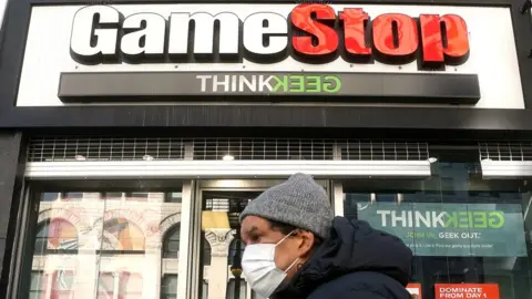 Reuters A person walks past a GameStop in the Manhattan borough of New York City, New York, U.S., January 29, 2021.