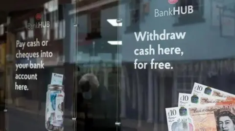 A generic image of a banking hub with £10 notes in the window