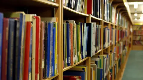 Getty Images Rows of books of different colours on wooden shelves