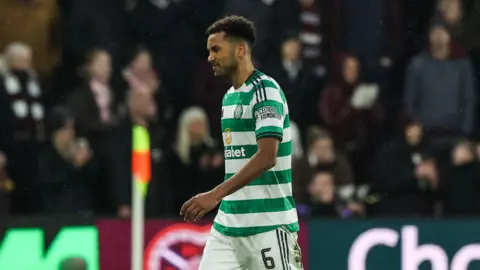 Auston Trusty walks off after being sent off at Tynecastle