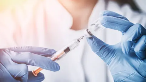 Getty Images scientist using flu jab