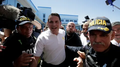 Reuters Fabricio Alvarado Muñoz, escorted away by police after casting his vote in February