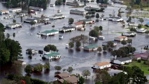 Reuters Homes sit in floodwater