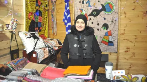 Woman at scarves stall