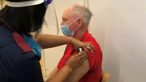 University Hospitals Birmingham Mr Lihou getting jab