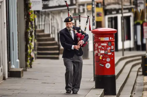 Getty Images Piper on Edinburgh's Royal Mile