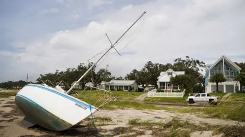 Getty Images A sailboat sits on the beach after Hurricane Ida passed on 30 August in Bay St. Louis, Mississippi