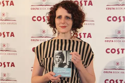 Getty Images Maggie O'Farrell at the Costa Book Award in 2010 with her book The Hand That First Held Mine