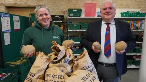 Tim Baldwin Helen Gilbert and Paul Kunes holding potatoes