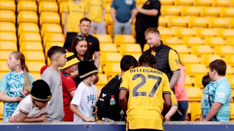 A Wolves player meeting young fans at Molineux