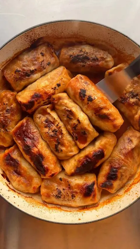 Rolls with charred tops in a pan