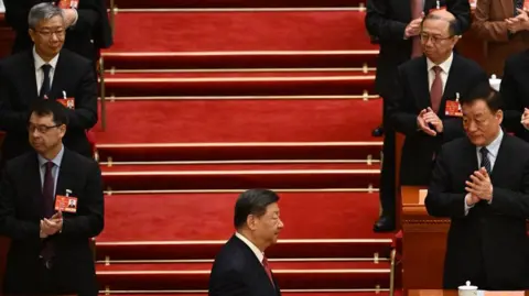 Getty Images China's President Xi Jinping arrives during the closing ceremony of the Chinese People's Political Consultative Conference at the Great Hall of the People in Beijing on March 10, 202