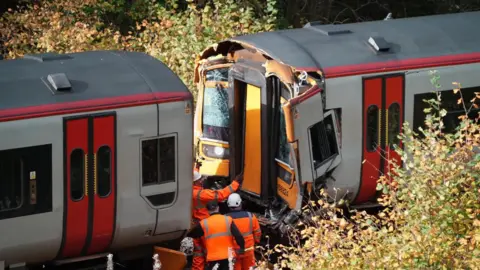 Image of two trains crashed into each other that have now been separated 