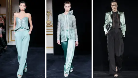 Getty Images Three looks from the Armani show - one model has flowing pale turquoise trousers and a corset top, the next wears a similar shade of trousers in silk, with  a matching jacket, and the third has black trousers, a sheer top and tie, and a pale mint structured jacket 