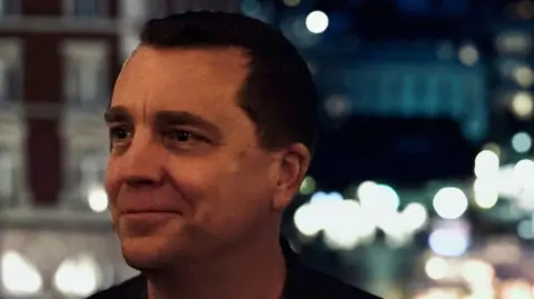 Contributed Damian Penfold standing in front of a blurred background