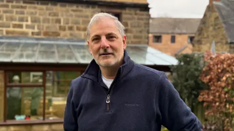 BBC Prof Tony Moore standing in front of his home 