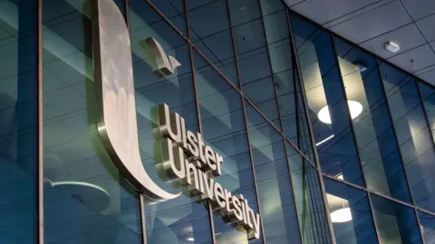 A glass building with a sign reading Ulster University