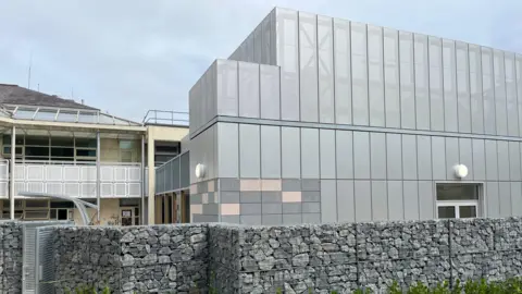 Critical Care Unit - a silver metal building