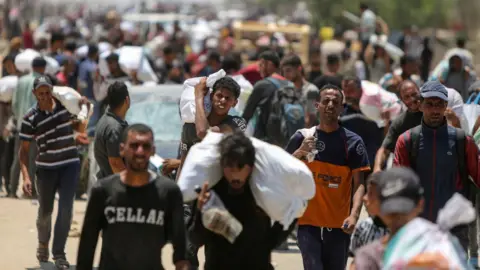 Reuters File photo showing Palestinians collecting aid supplies from the US-backed Gaza Humanitarian Foundation, in Rafah, in the southern Gaza Strip (9 June 2025)