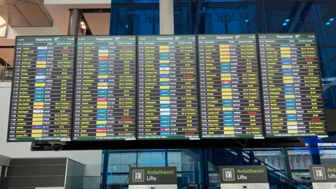 A large Flight information board at Dublin Airport showing cancelled Heathrow flights