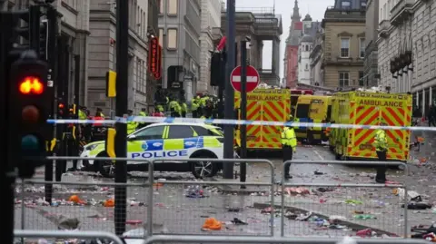 Police and emergency personnel dealing with an incident near the Liver Building in Liverpool during the Premier League winners' victory parade on 26 May 2025.