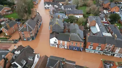 Darren Thompson A drone shot of Tenbury Wells which shows brown floodwater along the two of its main streets